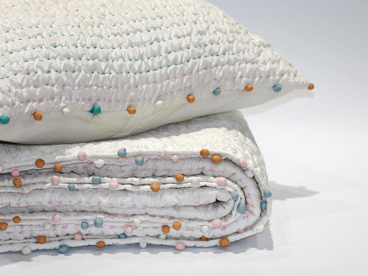 soft touch quilt with stitching details and pompoms170x220cm with one cushion cover