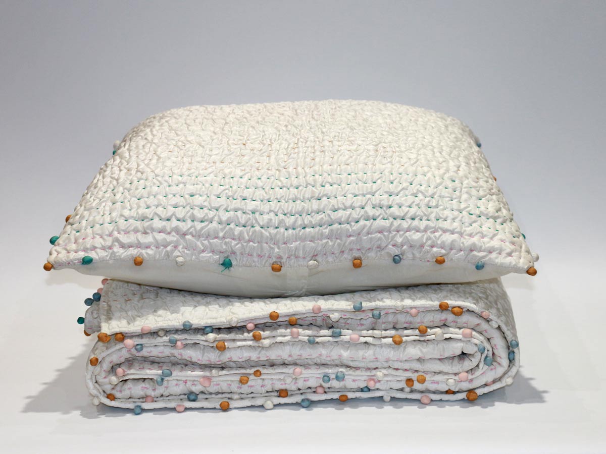 soft touch quilt with stitching details and pompoms170x220cm with one cushion cover