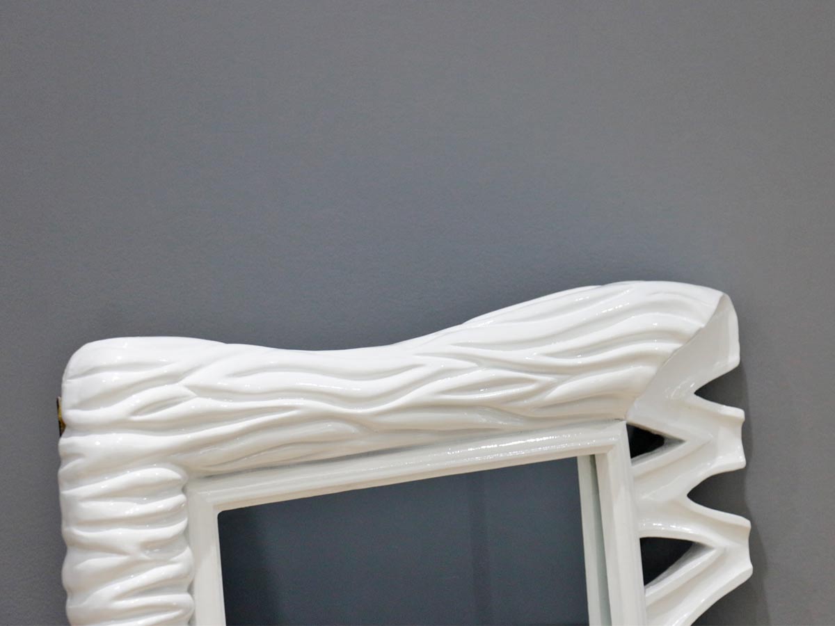 white frame mirror with wave design
