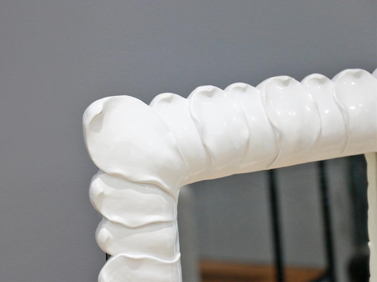 white frame mirror with petal design