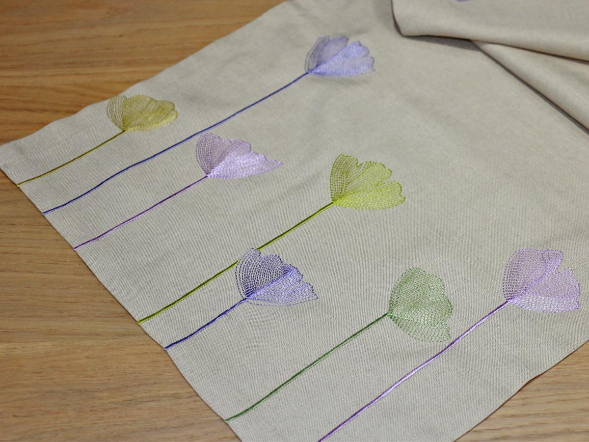 beige table runner with floral embroidery