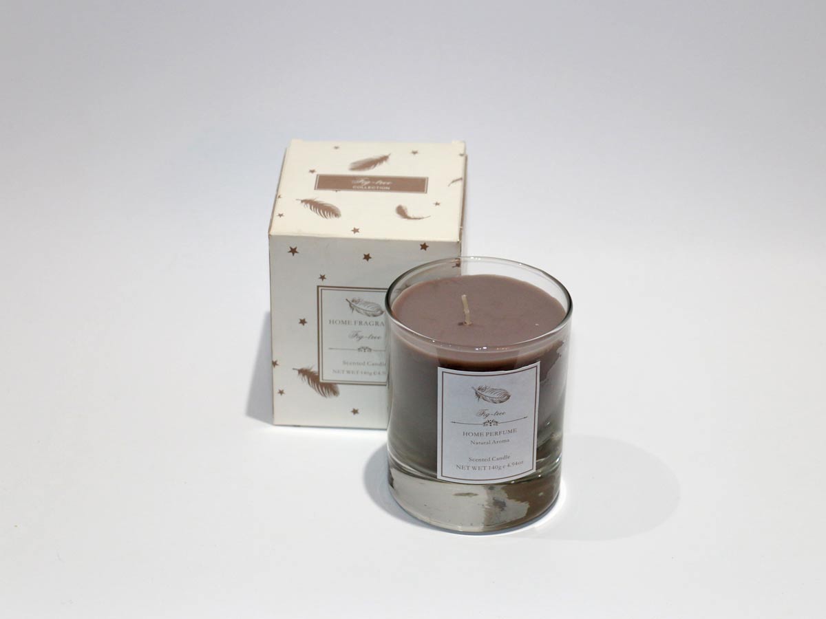 scented brown candle in glass