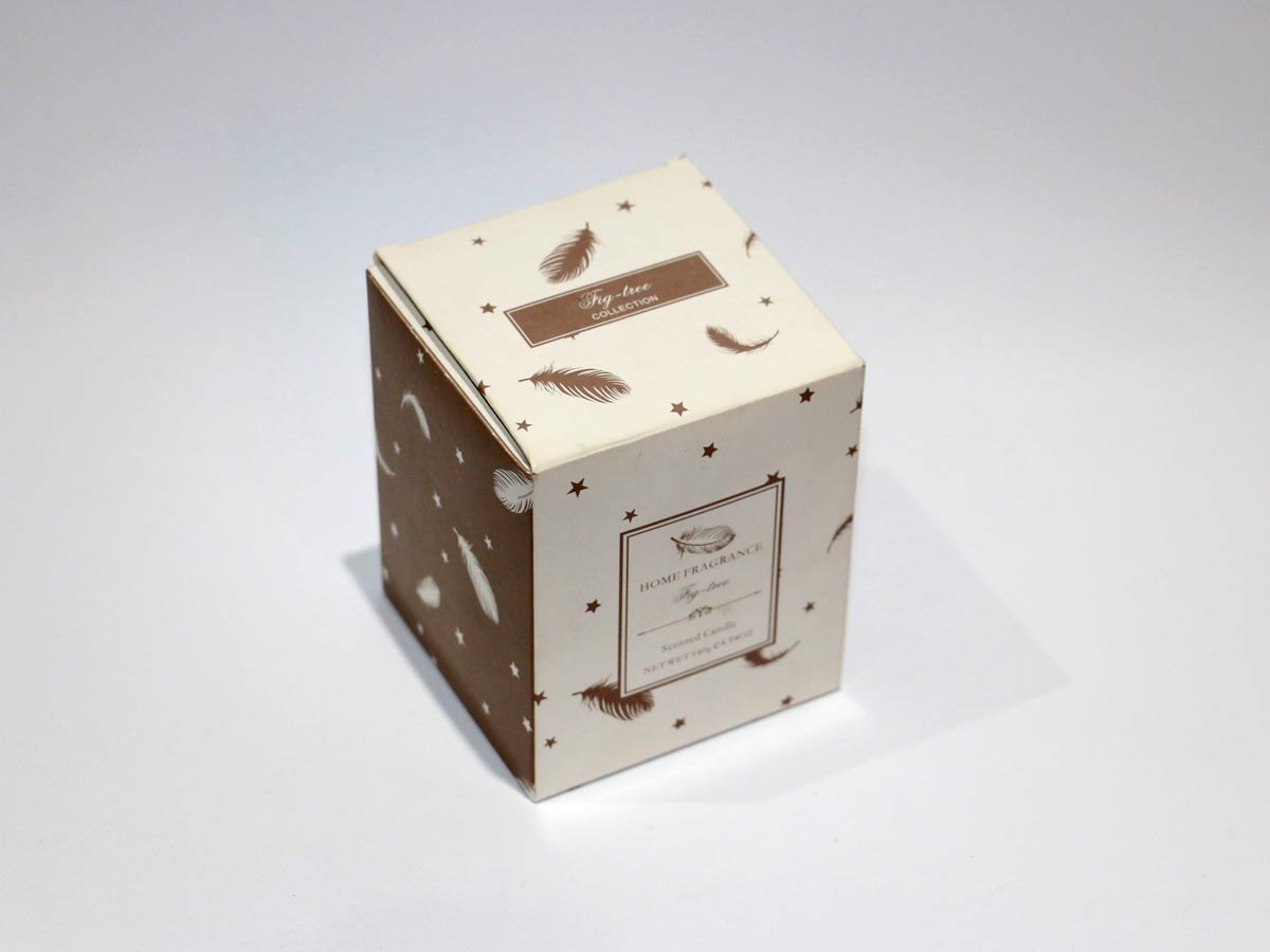 scented brown candle in glass