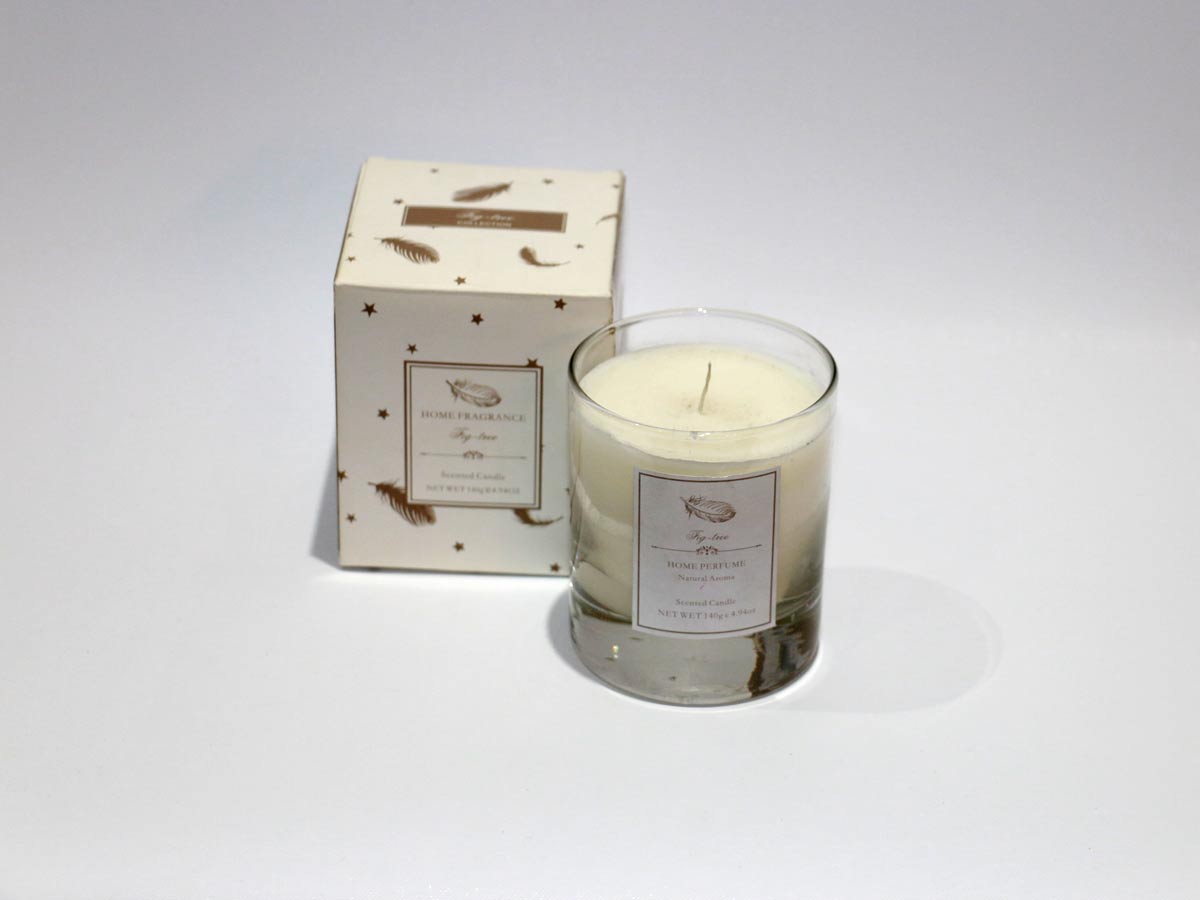 scented white candle in glass