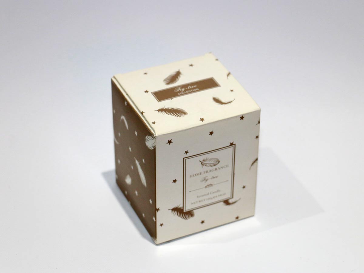 scented white candle in glass