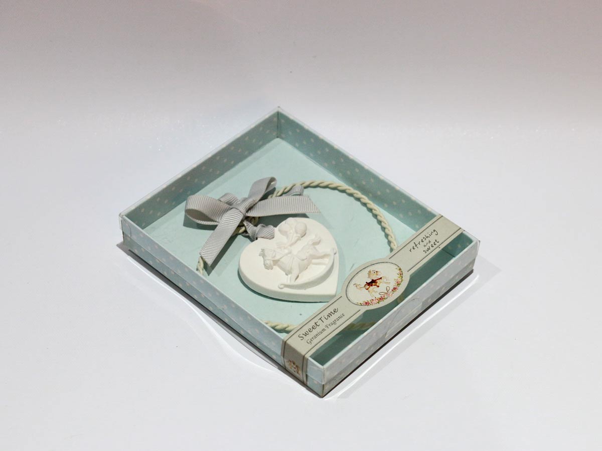 plaster horse with metal heart decoration