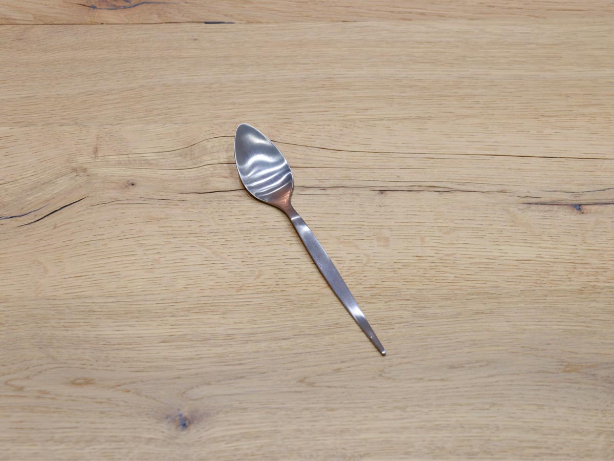 matte silver-colored stainless steel dessert spoon