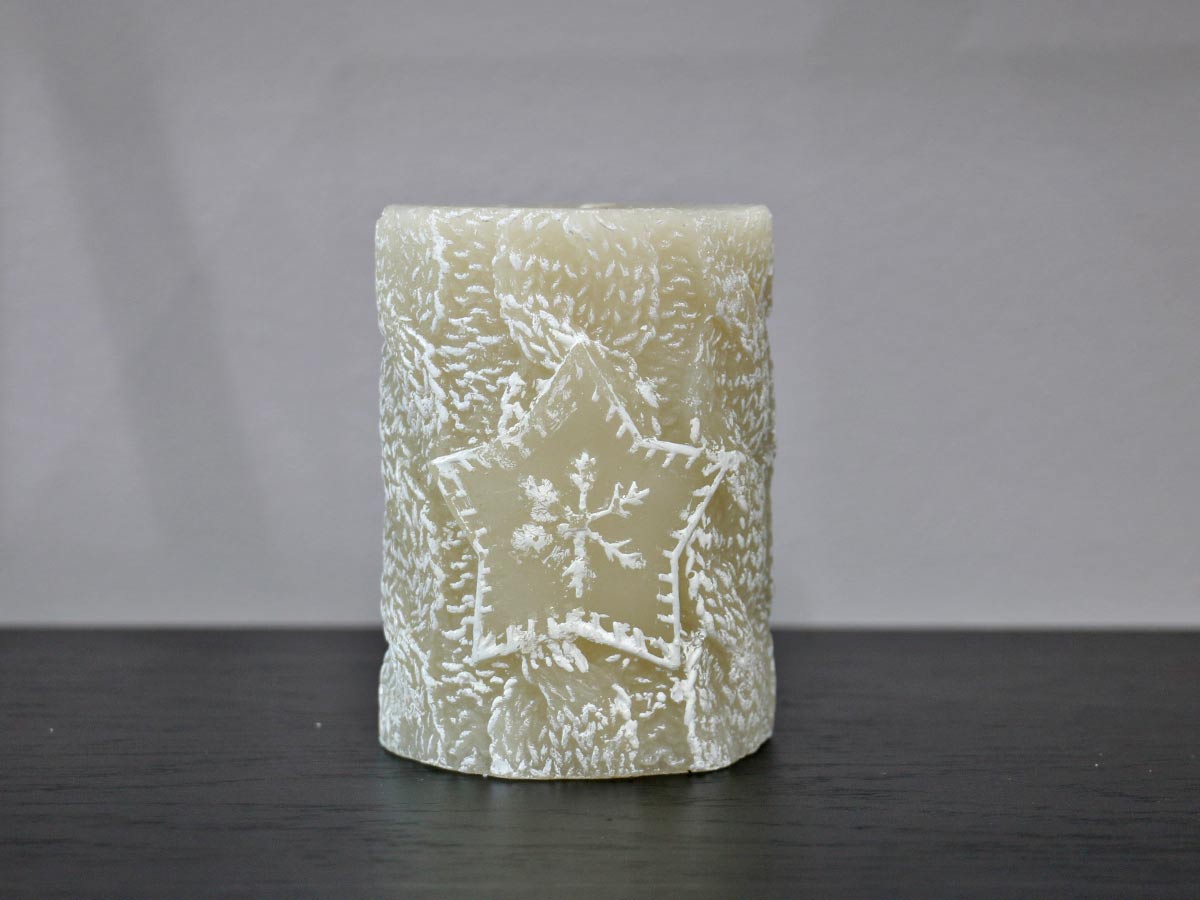 beige candle with snowflake