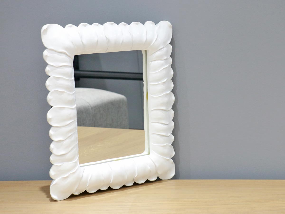 white frame mirror with petal design