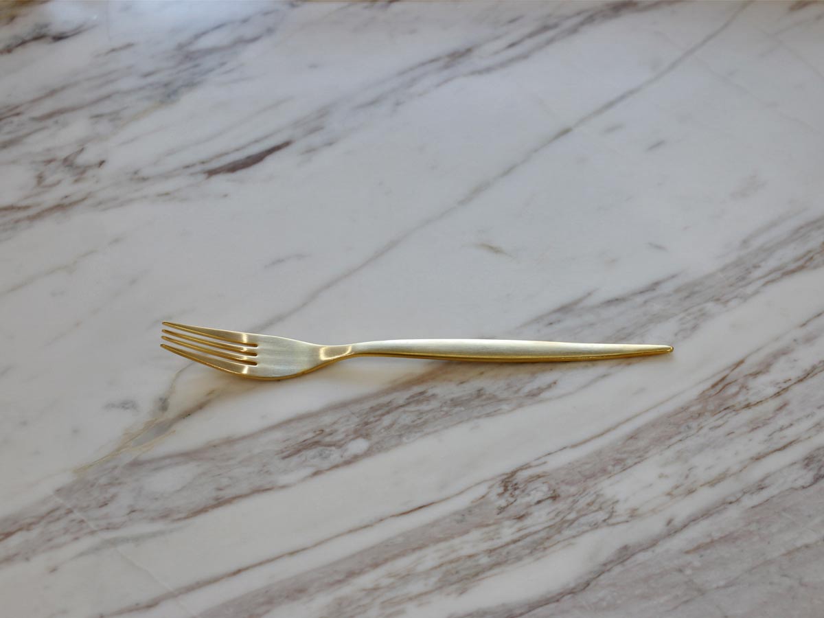 golden stainless steel table fork with matte finish