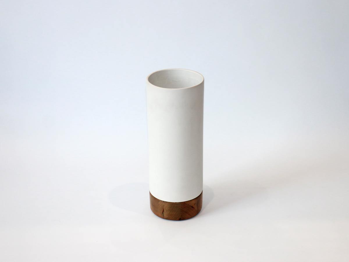 matt white vase with wooden base