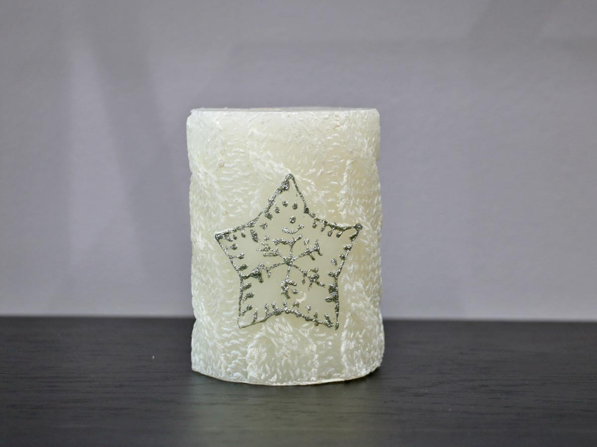 white candle with snowflake
