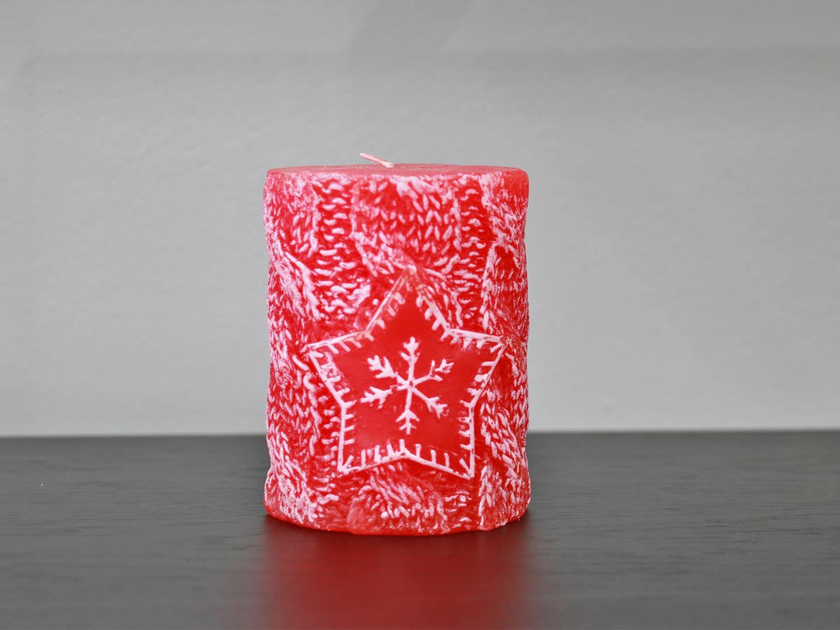 red candle with snowflake
